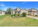 One-story house with a two-car garage and landscaped yard at 16792 Meadows St, Clermont, FL 34714
