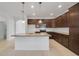 Modern kitchen with dark brown cabinets and island at 16792 Meadows St, Clermont, FL 34714