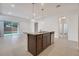 Kitchen island with granite countertop and sink, open to living area at 16792 Meadows St, Clermont, FL 34714