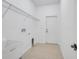 Laundry room with tile floor, shelving and a utility sink at 16792 Meadows St, Clermont, FL 34714