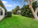 Spacious backyard featuring lush green grass and mature landscaping at 17412 Se 76Th Flintlock Ter, The Villages, FL 32162