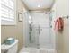 Modern walk-in shower featuring a new shower head and custom shelving for bath products at 17412 Se 76Th Flintlock Ter, The Villages, FL 32162