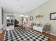 Cozy dining area featuring a wood table, a black and white rug, and access to the outdoor patio at 17412 Se 76Th Flintlock Ter, The Villages, FL 32162
