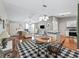 Stylish dining area with hardwood floors, a round table, and an open layout connecting to the living room and kitchen at 17412 Se 76Th Flintlock Ter, The Villages, FL 32162
