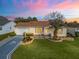 Charming single-story home with well-manicured lawn, painted driveway, and tropical landscaping at 17412 Se 76Th Flintlock Ter, The Villages, FL 32162