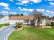 Single-story home with attached garage, driveway, and well-maintained lawn at 17412 Se 76Th Flintlock Ter, The Villages, FL 32162