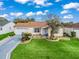 Inviting single-story home with a two car garage, a custom driveway and well-manicured lawn at 17412 Se 76Th Flintlock Ter, The Villages, FL 32162