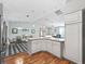 Kitchen island with seating overlooking the dining area and living spaces at 17412 Se 76Th Flintlock Ter, The Villages, FL 32162