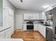 Bright kitchen with white cabinets, modern appliances, laminate countertops and wood floors at 17412 Se 76Th Flintlock Ter, The Villages, FL 32162