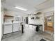 Functional laundry room featuring modern appliances, ample storage, and a utility sink for added convenience at 17412 Se 76Th Flintlock Ter, The Villages, FL 32162