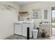 Functional laundry room featuring modern appliances, ample storage, and a utility sink for added convenience at 17412 Se 76Th Flintlock Ter, The Villages, FL 32162