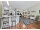 Bright open-concept living area featuring a breakfast bar and adjacent dining space with access to the backyard at 17412 Se 76Th Flintlock Ter, The Villages, FL 32162