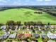 Aerial view showcases a neighborhood with lush green spaces and well-maintained homes at 17412 Se 76Th Flintlock Ter, The Villages, FL 32162