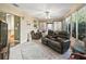 Bright and airy sunroom featuring tiled floors, comfortable seating, and large windows with outdoor views at 17412 Se 76Th Flintlock Ter, The Villages, FL 32162