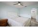 Light and airy bedroom with ceiling fan and ensuite bathroom at 17733 Se 107Th Ct, Summerfield, FL 34491