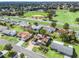 Aerial view of a residential neighborhood with lush greenery and a baseball field at 17744 Se 95Th Ct, Summerfield, FL 34491