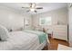 Bright bedroom with a queen-size bed, dresser, and desk at 17744 Se 95Th Ct, Summerfield, FL 34491