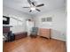 Comfortable bedroom featuring hardwood floors and ceiling fan at 17744 Se 95Th Ct, Summerfield, FL 34491