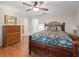 Charming bedroom with a floral bedspread and wood dresser at 17744 Se 95Th Ct, Summerfield, FL 34491