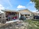 Rear view of a single story house with covered patio, workshop and storage at 17744 Se 95Th Ct, Summerfield, FL 34491