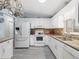 White kitchen features granite countertops, stainless steel appliances, and ample cabinet space at 17744 Se 95Th Ct, Summerfield, FL 34491