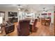 Spacious living room with hardwood floors, leather furniture, and a view of the kitchen at 17744 Se 95Th Ct, Summerfield, FL 34491