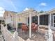 Covered patio with seating area, providing a shaded spot for relaxation at 17744 Se 95Th Ct, Summerfield, FL 34491