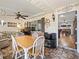 Bright sunroom with tiled floors, table and chairs, and access to the backyard at 17744 Se 95Th Ct, Summerfield, FL 34491