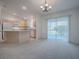 Dining area with kitchen and access to patio at 1930 Harston Trl, The Villages, FL 32162