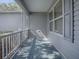 Screened porch with white railing and window at 1930 Harston Trl, The Villages, FL 32162