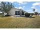 Side yard with screened porch and landscaping at 2001 Cristo Rd, Lady Lake, FL 32159
