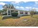 Back exterior view with screened porch and yard at 2001 Cristo Rd, Lady Lake, FL 32159