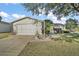 Single story home with garage and landscaped yard at 2001 Cristo Rd, Lady Lake, FL 32159