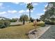Landscaped front yard with palm trees and shrubs at 2001 Cristo Rd, Lady Lake, FL 32159