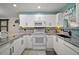 Modern kitchen with granite countertops and white cabinets at 2001 Cristo Rd, Lady Lake, FL 32159