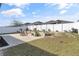 Landscaped backyard with fire pit and spacious patio at 2029 Sloans Outlook Dr, Groveland, FL 34736