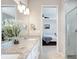 Main bathroom with double vanity, granite countertop, and a view of bedroom at 2029 Sloans Outlook Dr, Groveland, FL 34736