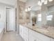 Double vanity bathroom with granite countertops and a soaking tub at 2029 Sloans Outlook Dr, Groveland, FL 34736