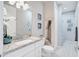 Guest bathroom with single vanity, granite countertop, and shower at 2029 Sloans Outlook Dr, Groveland, FL 34736