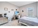 Bright bedroom with a bed, desk, and window at 2029 Sloans Outlook Dr, Groveland, FL 34736