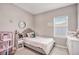 Cozy bedroom with a twin bed, neutral decor and plenty of natural light at 2029 Sloans Outlook Dr, Groveland, FL 34736