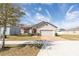 One-story home with a two-car garage and landscaped yard at 2029 Sloans Outlook Dr, Groveland, FL 34736