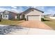 House exterior with brick and landscaping at 2029 Sloans Outlook Dr, Groveland, FL 34736
