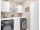 Laundry room with washer, dryer, and cabinets at 2029 Sloans Outlook Dr, Groveland, FL 34736
