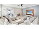 Spacious living area featuring a sectional sofa, media wall, and access to the backyard patio at 2029 Sloans Outlook Dr, Groveland, FL 34736