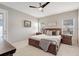 Bright main bedroom with a king-size bed and ensuite bathroom access at 2029 Sloans Outlook Dr, Groveland, FL 34736