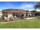 Inviting backyard with screened patio, landscaping, and grassy area at 21837 Royal St Georges Ln, Leesburg, FL 34748