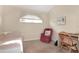 Cozy bedroom featuring a comfortable bed, chair, and workspace at 21837 Royal St Georges Ln, Leesburg, FL 34748