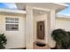 Front entrance with brick columns, screen door, and landscaping at 21837 Royal St Georges Ln, Leesburg, FL 34748