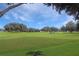 Expansive golf course view with players visible at 21837 Royal St Georges Ln, Leesburg, FL 34748